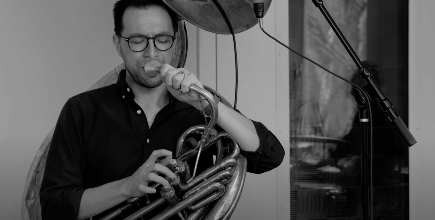 Black-and-white photo of Neil playing sousaphone